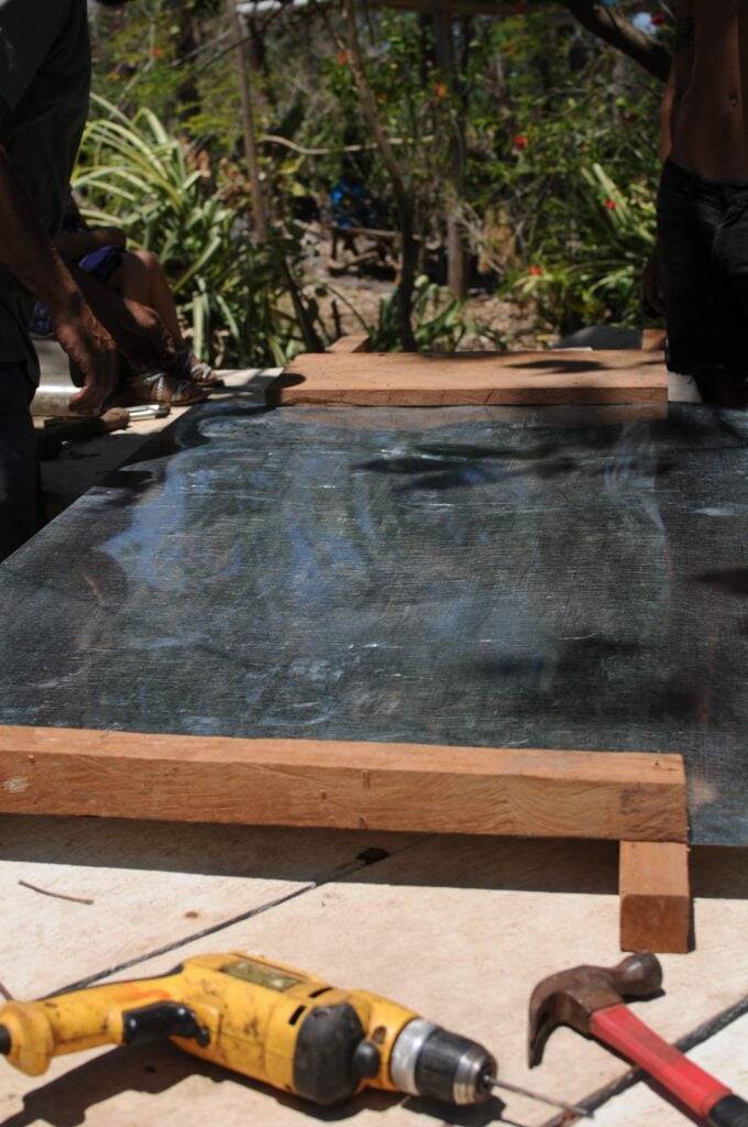 The first piece of the base nailed down.