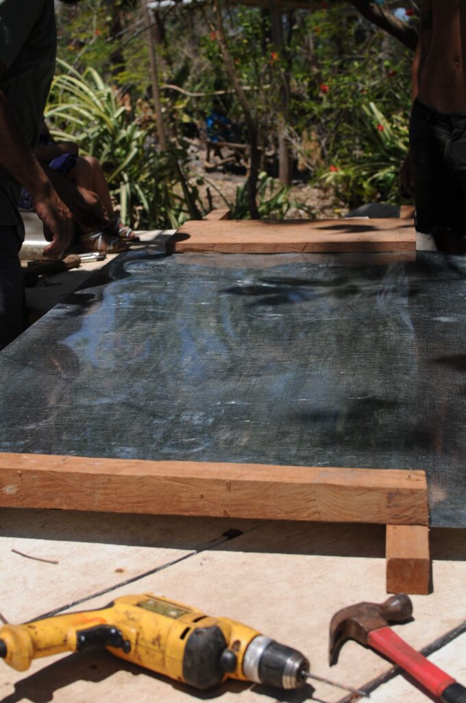 The first piece of the base nailed down.