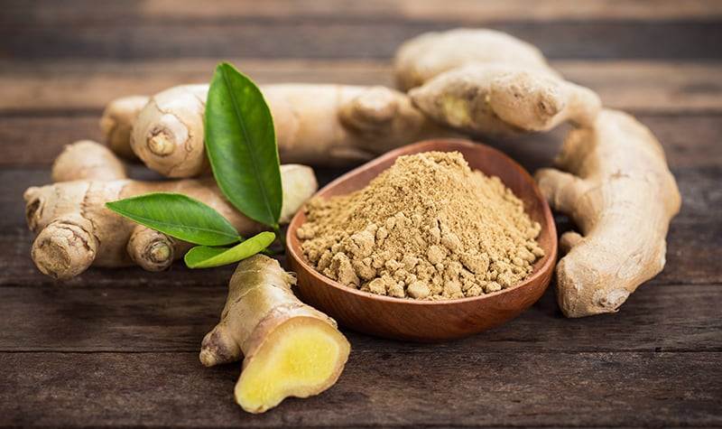 ginger root and ginger powder in the bowl